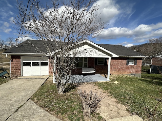 ranch-style home with a garage, concrete driveway, covered porch, a front lawn, and brick siding