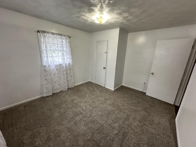 empty room with carpet floors and baseboards