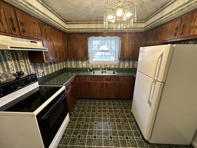 kitchen featuring range with electric cooktop, dark countertops, freestanding refrigerator, under cabinet range hood, and a sink