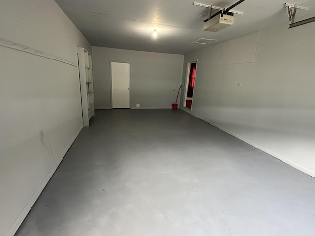 garage with a garage door opener and baseboards