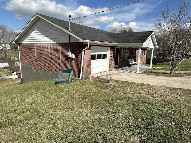 view of side of property featuring a garage, concrete driveway, a lawn, and brick siding