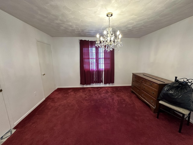 interior space featuring an inviting chandelier, baseboards, and a textured ceiling