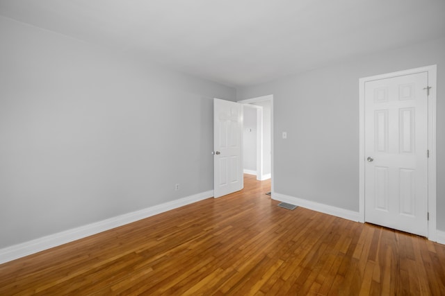 unfurnished room featuring wood-type flooring