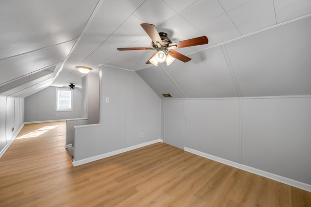 additional living space featuring light wood-type flooring, vaulted ceiling, and ceiling fan