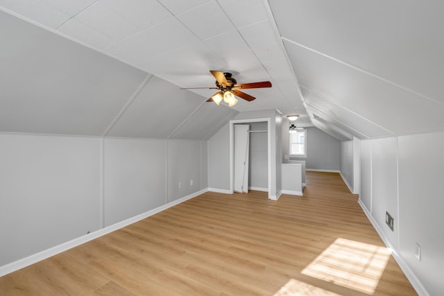 bonus room with ceiling fan, light hardwood / wood-style flooring, and vaulted ceiling