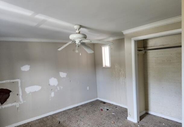 unfurnished bedroom with ceiling fan, a closet, carpet, and ornamental molding