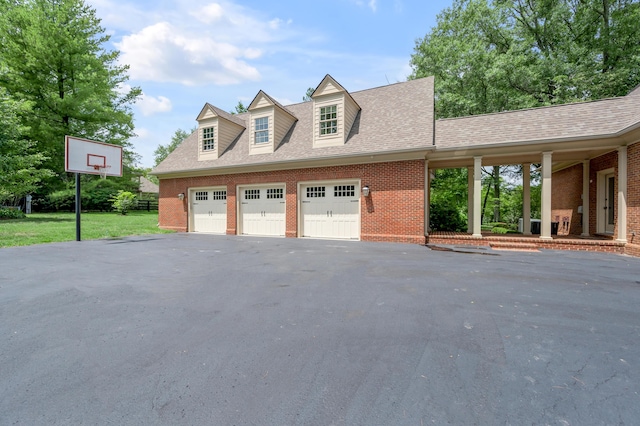 1821 Delong Rd, Lexington, KY 40515 - exterior space featuring brick siding, a yard, aphalt driveway, roof with shingles, and an attached garage
