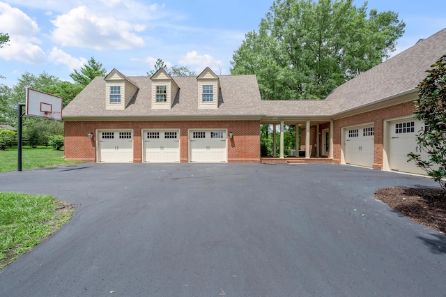 1821 Delong Rd, Lexington, KY 40515 - cape cod house with a garage, brick siding, and a shingled roof