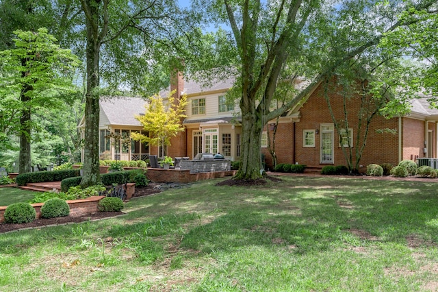 1821 Delong Rd, Lexington, KY 40515 - rear view of property featuring a lawn, central air condition unit, brick siding, and a chimney