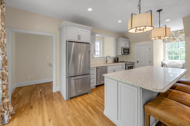 1821 Delong Rd, Lexington, KY 40515 - kitchen with a wealth of natural light, appliances with stainless steel finishes, light wood finished floors, and a kitchen island