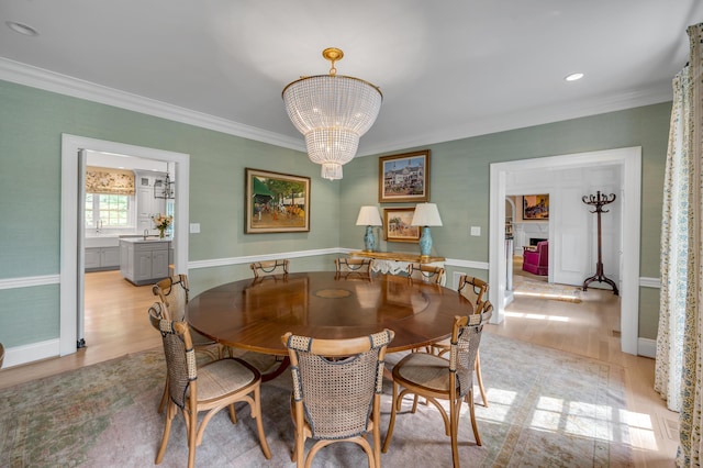 1821 Delong Rd, Lexington, KY 40515 - dining room with baseboards, ornamental molding, a fireplace, wood finished floors, and a notable chandelier