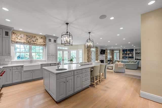 1821 Delong Rd, Lexington, KY 40515 - kitchen with gray cabinetry, an inviting chandelier, a sink, and a kitchen island with sink