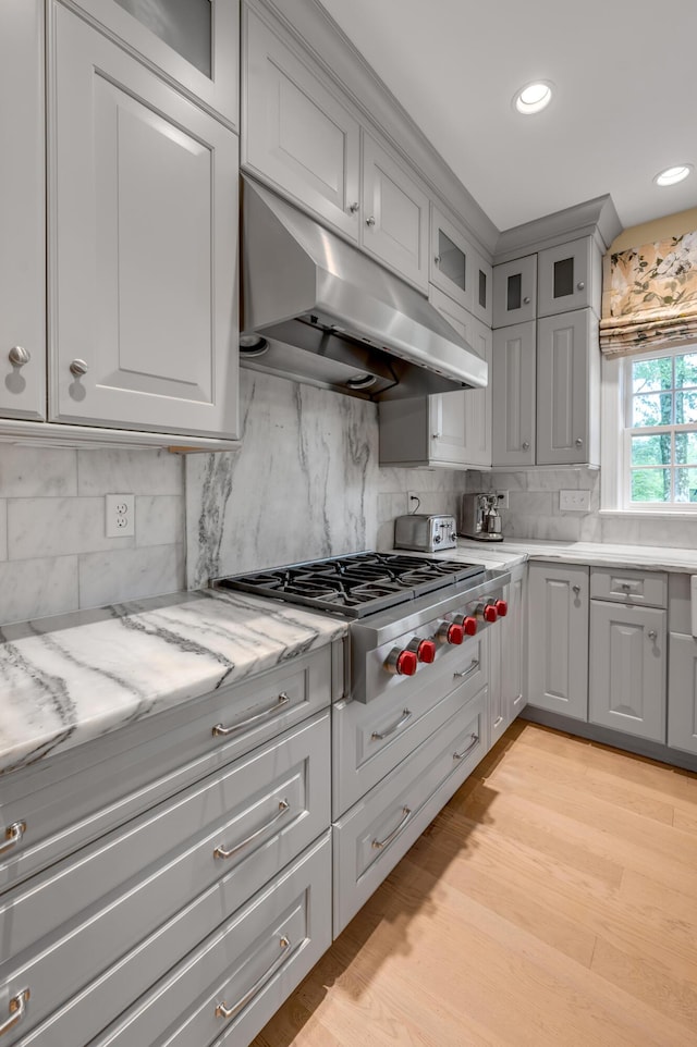 1821 Delong Rd, Lexington, KY 40515 - kitchen with backsplash, stainless steel gas cooktop, gray cabinets, and under cabinet range hood
