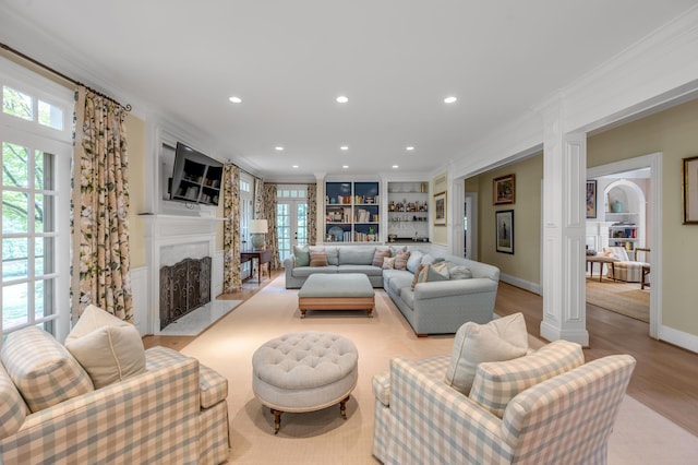 1821 Delong Rd, Lexington, KY 40515 - living room featuring decorative columns, a healthy amount of sunlight, and built in features