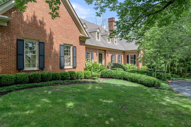 1821 Delong Rd, Lexington, KY 40515 - exterior space featuring a front lawn, a chimney, and brick siding