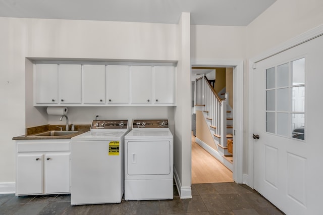1821 Delong Rd, Lexington, KY 40515 - laundry area with separate washer and dryer, dark tile patterned floors, cabinet space, a sink, and baseboards