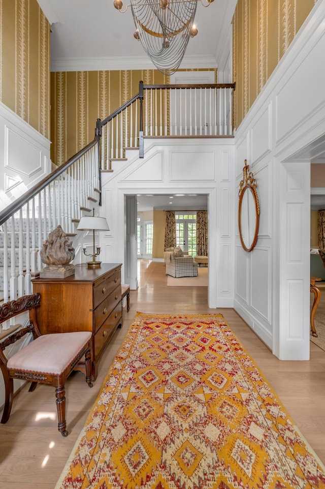 1821 Delong Rd, Lexington, KY 40515 - entrance foyer featuring crown molding, stairway, wallpapered walls, a decorative wall, and a notable chandelier