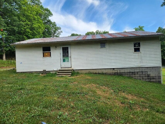 rear view of property with a lawn