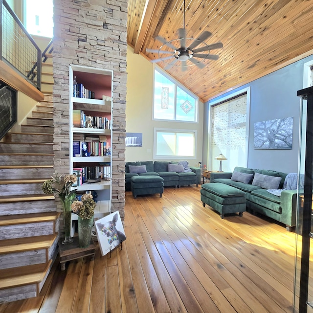 living room with stairway, high vaulted ceiling, ceiling fan, wood-type flooring, and wooden ceiling