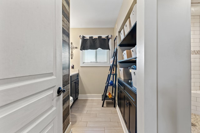 walk in closet with wood tiled floor