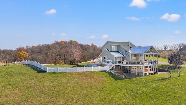 rear view of property featuring stairway, a wooden deck, a fenced backyard, a yard, and a patio