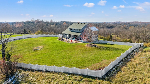 drone / aerial view featuring a forest view