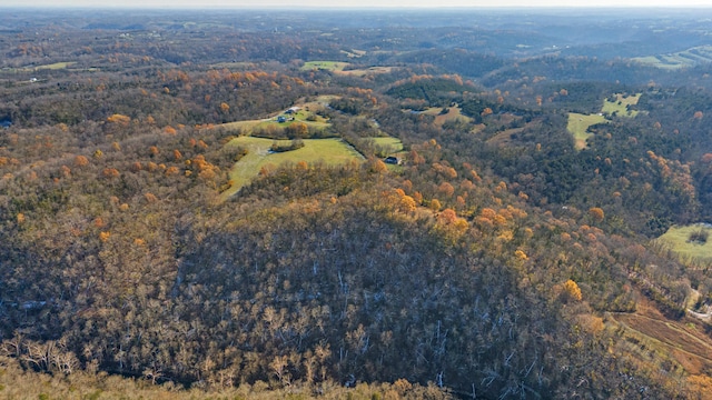 birds eye view of property with a view of trees