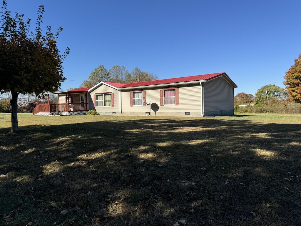 rear view of property with a lawn