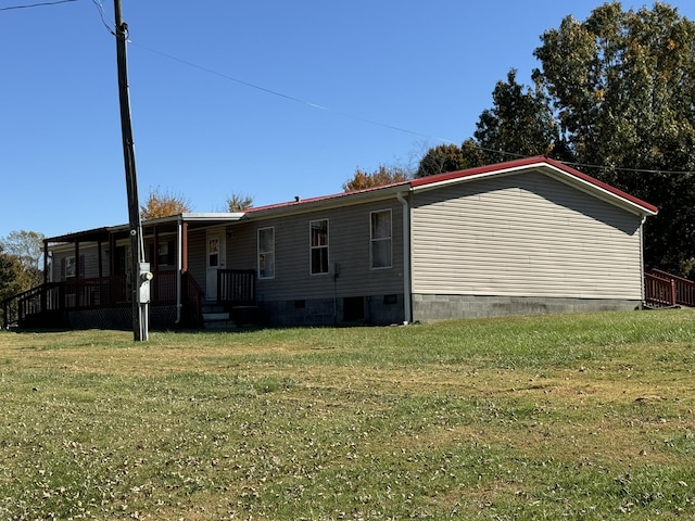 rear view of property with a yard