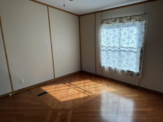 empty room with ceiling fan and wood-type flooring