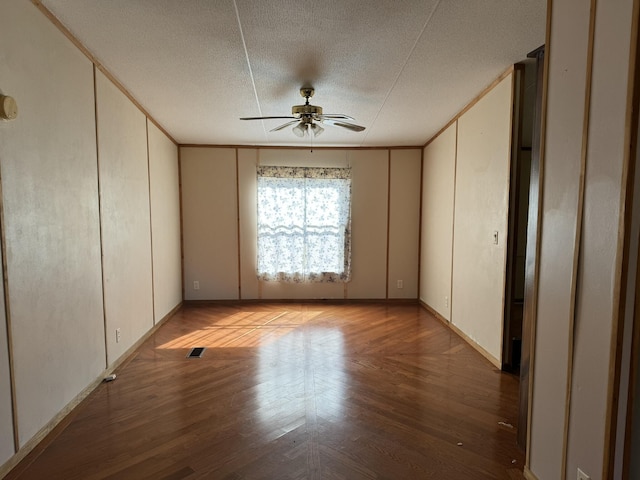 spare room featuring ceiling fan, ornamental molding, and a textured ceiling