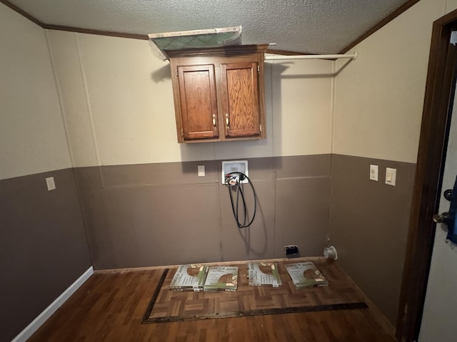 laundry area with hardwood / wood-style floors, cabinets, a textured ceiling, and washer hookup