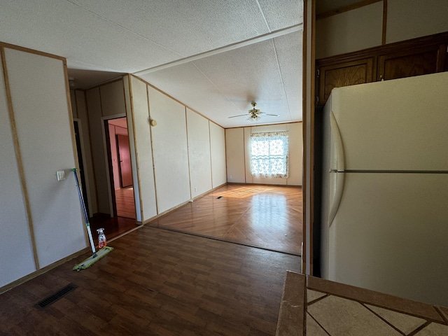 kitchen featuring wood-type flooring, a textured ceiling, white fridge, and ceiling fan