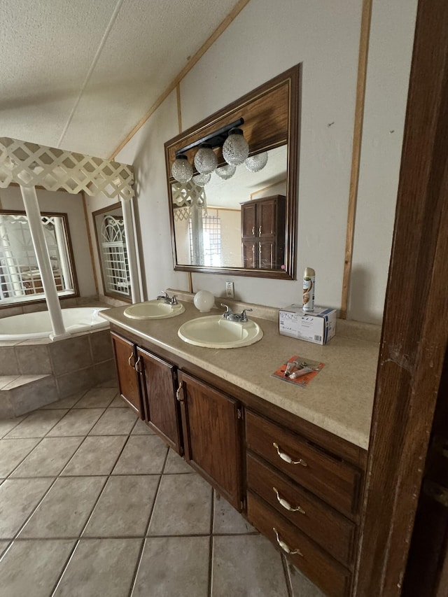 bathroom with tile patterned floors, vanity, a textured ceiling, crown molding, and a relaxing tiled tub