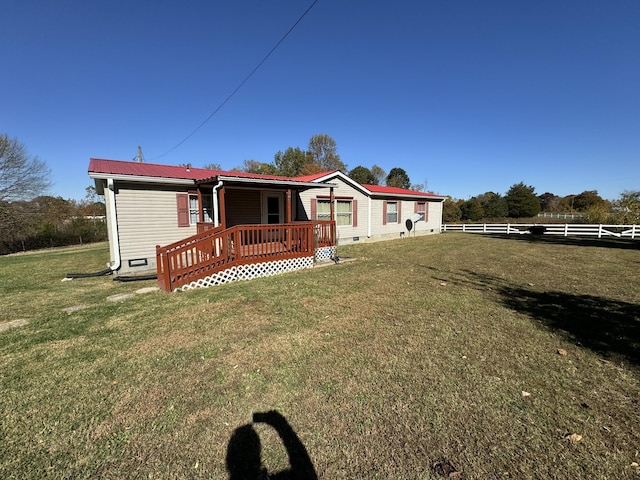 exterior space with a wooden deck and a lawn