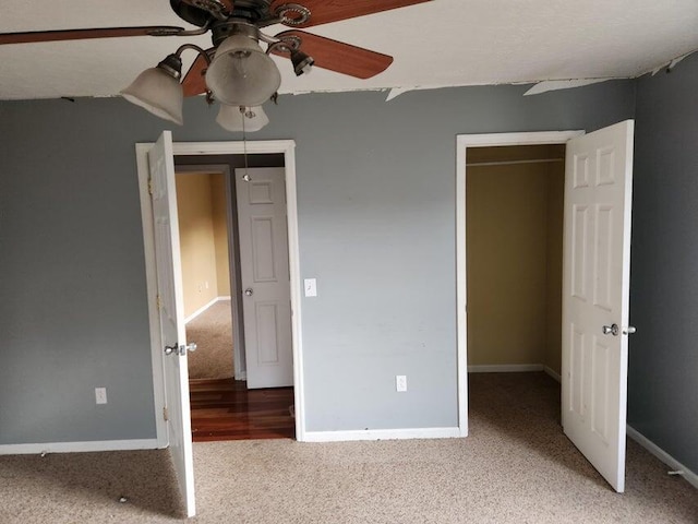 unfurnished bedroom with carpet flooring, ceiling fan, and a closet