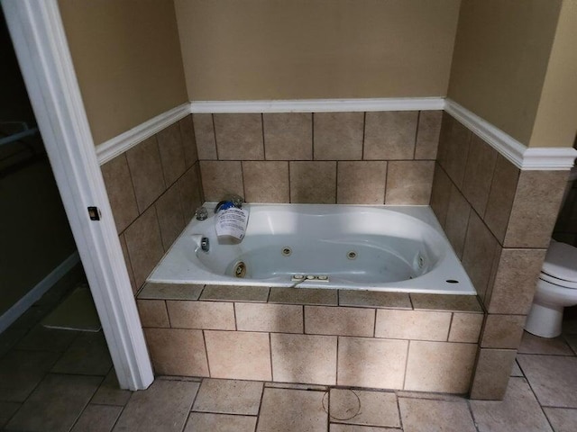 bathroom with tiled bath and toilet