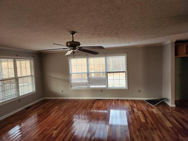 spare room featuring a wealth of natural light, ceiling fan, dark wood-type flooring, and ornamental molding