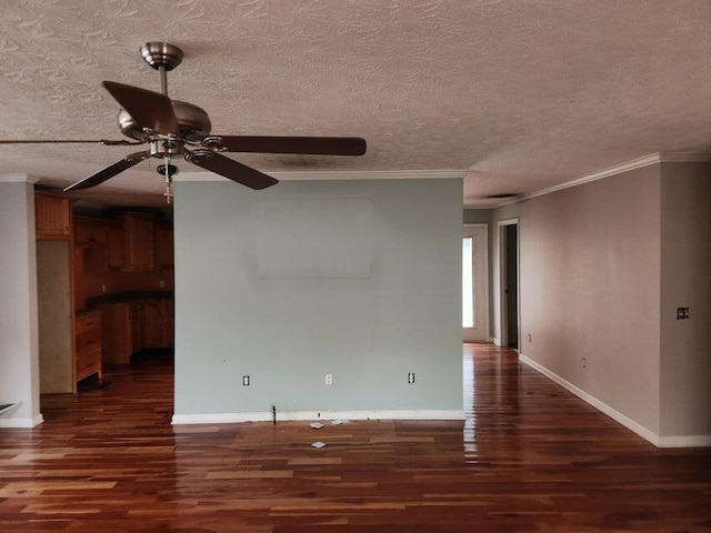 empty room with dark hardwood / wood-style floors, ceiling fan, ornamental molding, and a textured ceiling