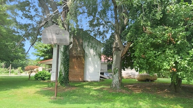 view of side of home featuring a lawn