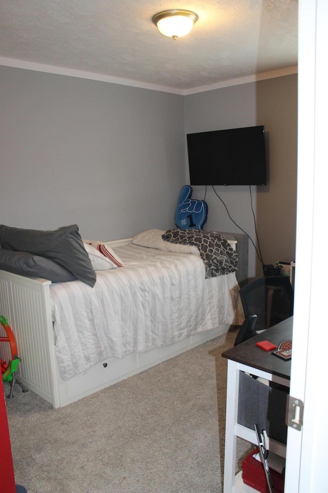 bedroom with carpet and a textured ceiling