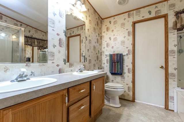 bathroom featuring vanity, crown molding, toilet, a textured ceiling, and walk in shower