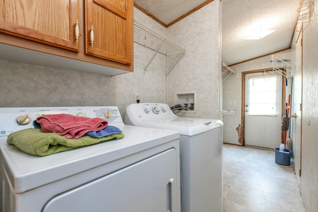 laundry room with cabinets, a textured ceiling, washer and clothes dryer, and ornamental molding