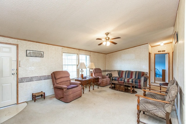 living room featuring lofted ceiling, crown molding, ceiling fan, a textured ceiling, and carpet floors