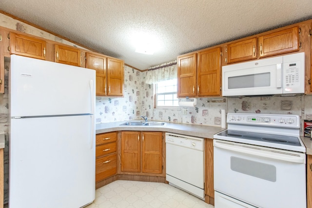 kitchen with a textured ceiling, sink, vaulted ceiling, and white appliances