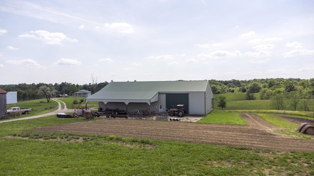 rear view of property featuring an outbuilding