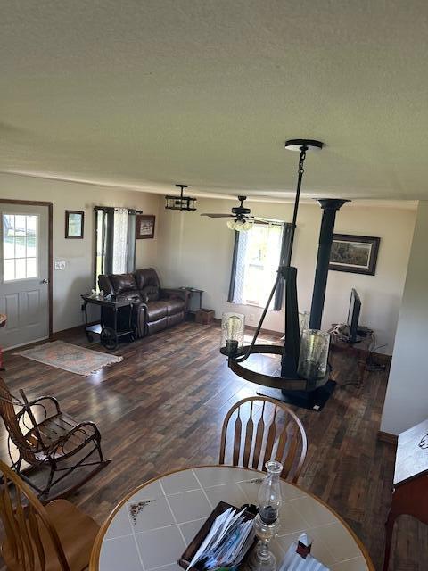 living room with hardwood / wood-style floors, a textured ceiling, and a wealth of natural light