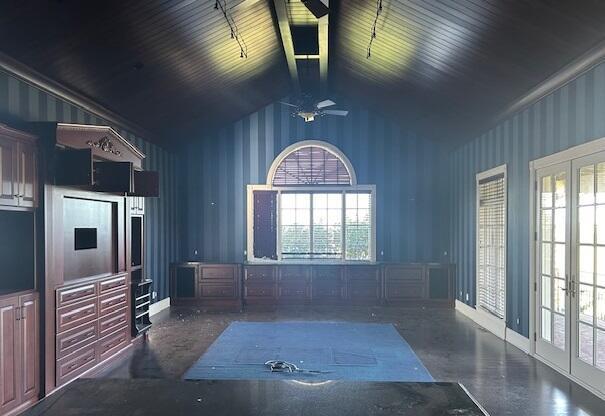 interior space with ceiling fan, high vaulted ceiling, and french doors