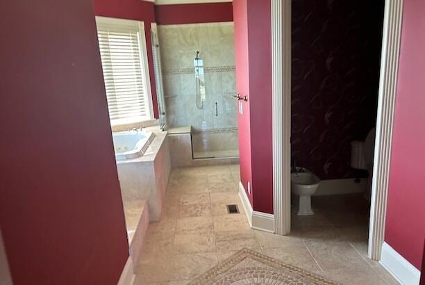 bathroom featuring tile patterned floors, a bidet, and independent shower and bath