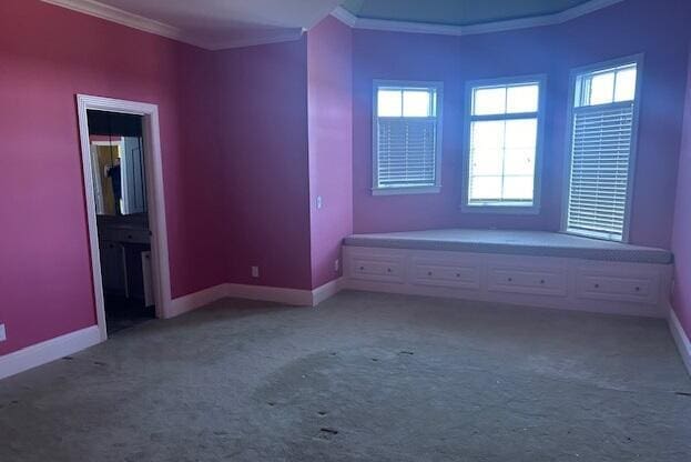 unfurnished bedroom featuring carpet floors and crown molding